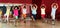 Childrens trying balance movements of ballet in classroom