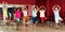 Childrens trying balance movements of ballet in classroom