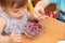 Childs eating quick-frozen raspberries