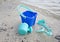 A childs green beach bucket and spades