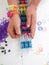 Childs hands with loom and multicoloured elastic bands