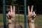 Childs hands making peace signs