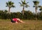 Childs pose. Adult caucasian woman practice evening yoga on the grass outdoor in vacation, selective focus.