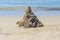 A Childs sand castle waiting for the ocean tide to come in to reclaim it