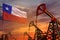 Chile oil industry concept. Industrial illustration - Chile flag and oil wells with the red and blue sunset or sunrise sky