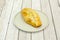 Chilean beef empanada on gray plate on light wooden table