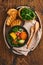 Chilean meat soup with pampkin, corn, fresh coriander and potatoes on old wooden table background. Cazuela. Latinamerican food