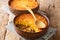 Chilean shepherd`s pie, pastel de choclo tops spiced ground beef with a purÃ©ed corn crust closeup in the pots. Horizontal