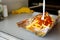 Chili cheese fries hot and ready on vendor counter