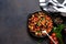 Chili con carne classic mexican dish on the kitchen table, top view