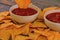 Chili corn-chips with salsa dip on wooden background