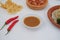 chili paste and chili on the table with crackers and vegetables