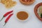 chili paste and chili on the table with crackers and vegetables