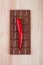 Chili pepper and chocolate on chopping board