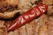 Chili pepper close-up on hot roast meat background