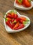 Chili red pepper mini pods in a plate heart close up selective focus