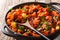 Chili sweet potatoes and black beans with tomatoes, celery close-up in a pan. horizontal