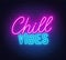 Chill Vibes neon lettering on brick wall background.