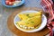 Chilla, tortillas or pancakes made from chickpea flour stuffed with cheese panir and tomato on a white plate
