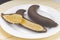 Chilled bananas, left at room temperature with mushy flesh on a white plate