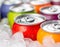 Chilled Colorful Soda Cans. A variety of cold soda cans nestled in ice, showcasing an inviting and refreshing beverage option