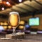 Chilled glass of light beer on old wooden table