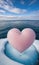 Chilled Romance: A Frozen Pink Heart Floating in an Icy Ocean Beneath a Blue Cloudy Sky