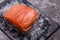 Chilled salmon fillet on a gray stone background