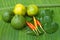 Chilli kaffir and lemon lime on green banana leaves.