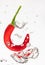 Chilli pepper falling in water on white