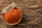 Chilli powder in a rustic wooden bowl