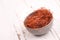 Chilli threads in a bowl on a white shabby background