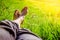 Chilling in the green grass: Legs of a young man, relaxing, summertime