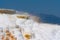 Chilling view of a snow-covered cliff against blue sky