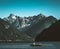 Chilliwack Lake mountain panorama with boat in the foreground and deep blue sky.