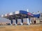 Chillout gas and oil station that is under construction with a blue sky, a construction site of a petrol gas station