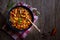 Chilly beans with hot pepper on dark wooden background