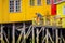 CHILOE, CHILE - SEPTEMBER, 27, 2018: Unidentified man in his yellow house on stilts palafitos in Castro, Chiloe Island