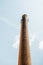 Chimney brick smoke stack with mobile phone antenna on top
