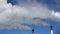 Chimney of factory plant against blue sky