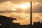 Chimney of a factory at sunrise