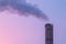 Chimney of an incineration plant, dawn windy morning