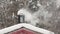 Chimney pipe in snowdrift. Winter using the stove, white smoke. Forest on background