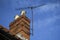 Chimney on a roof with TV aerial and blue sky with light cloud