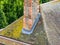 A chimney stack with new lead flashing and roof tile details.