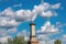 chimney, surrounded by fluffy clouds, against the backdrop of blue sky