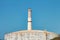 The chimney of the Tel Aviv Reading power plant near a large natural gas storage tank