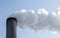 chimney with thick clouds of smoke or steam, concept for economic growth and environmental pollution by co2 and fine dust, blue s