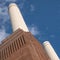 Chimneys at Battersea Power Station, renovated interwar building, now a mixed use retail and residential scheme.