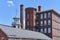 Chimneys, a cupola and buildings of restored Boott Cotton Mills in Lowell, MA